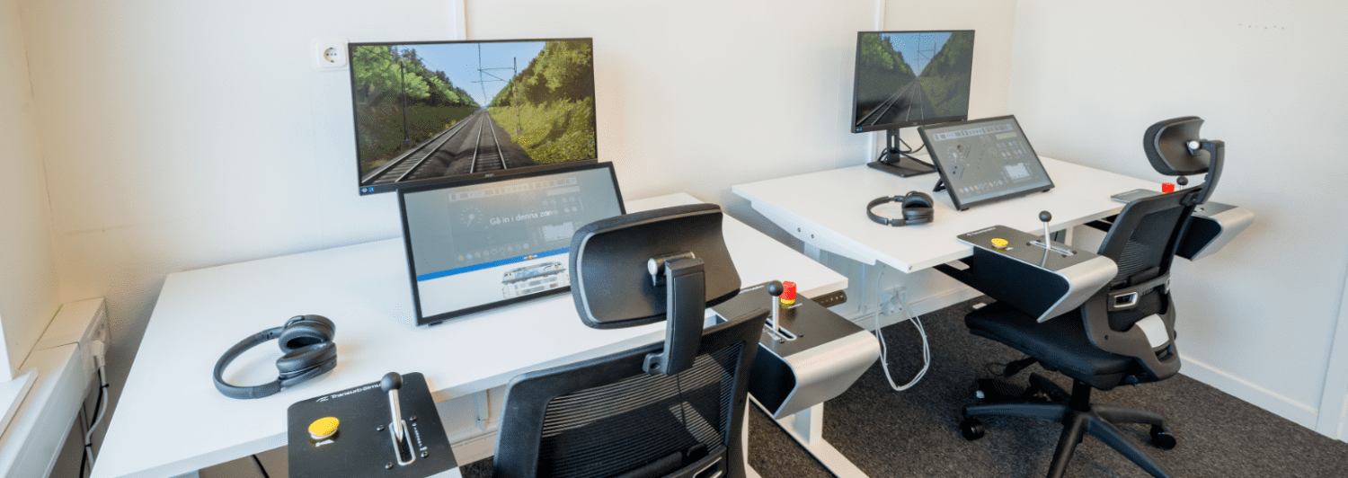 Two Nano train simulators set up in a bright training room at SJ, Sweden, used for driver training across multiple centres.