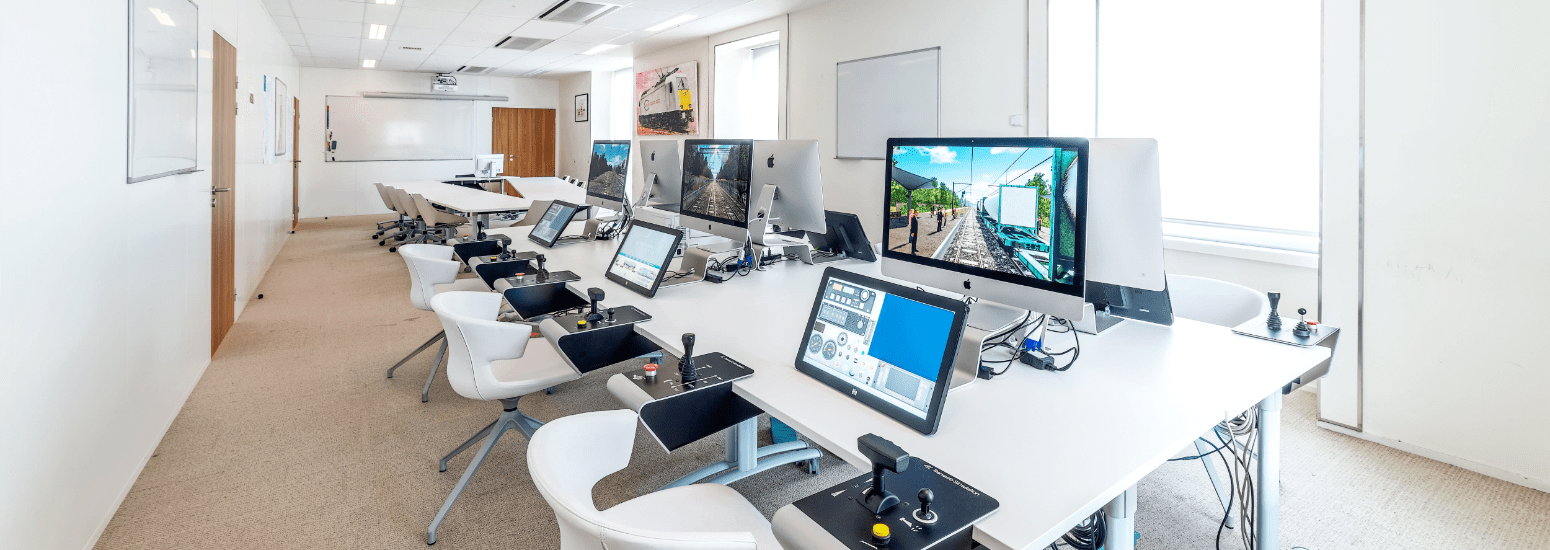 Training room with eight Nano Simulators for freight driver training at DB Cargo France.